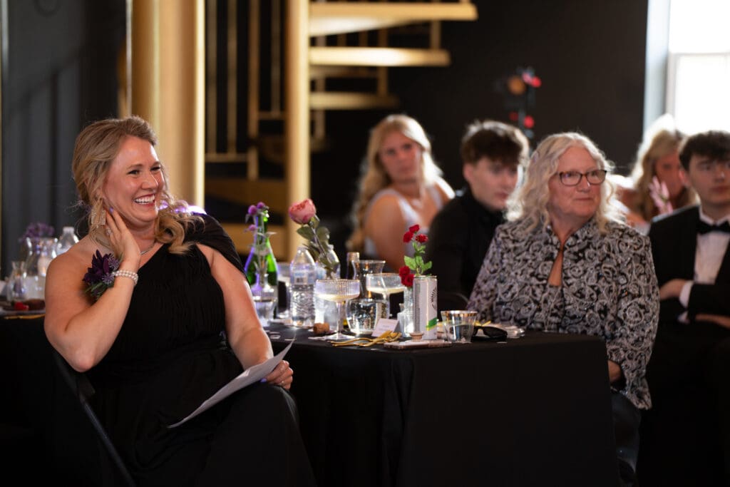 Wedding reception guests seated at decorated tables enjoying dinner during an Iowa celebration